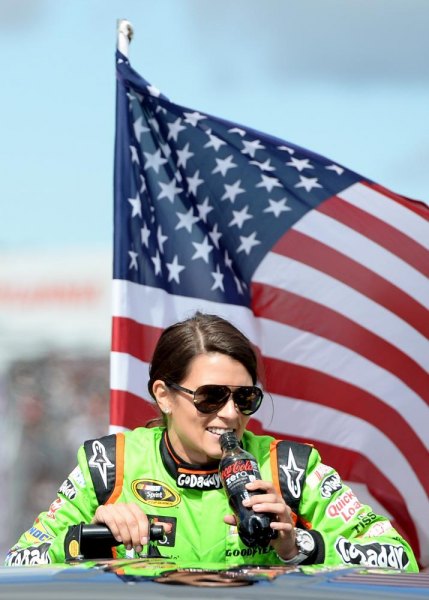 Danica Patrick, driver of the #10 GoDaddy Chevrolet, looks on during driver introductions prior to the NASCAR Sprint Cup Series Sylvania 300 at New Hampshire Motor Speedway on September 22, 2013 in Loudon, New Hampshire. Danica Patrick, driver of the #10 GoDaddy Chevrolet, looks on during driver introductions prior to the NASCAR Sprint Cup Series Sylvania 300 at New Hampshire Motor Speedway on September 22, 2013 in Loudon, New Hampshire.