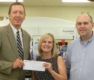 Fruth Pharmacy provides Marshall University with scholarship support gifts Dr. Kevin Yingling, dean of the School of Pharmacy, left, accepts a gift from Lynne Fruth, president and chairman of the board, Fruth Pharmacy, Inc., and Tim Weber, director of pharmacy administration and procurement.