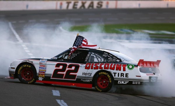 NASCAR: Brad Keselowski outduels Denny Hamlin for NNS win at Texas FORT WORTH, TX - NOVEMBER 02: Brad Keselowski, driver of the #22 Discount Tire Ford, celebrates after winning the NASCAR Nationwide Series O'Reilly Auto Parts 300 at Texas Motor Speedway on November 2, 2013 in Fort Worth, Texas.