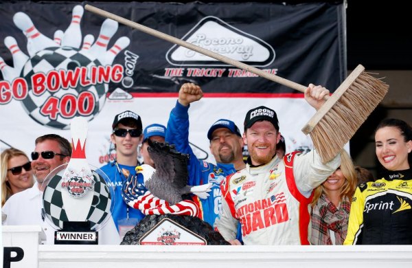 Earnhardt Jr. holds off Harvick to complete Sprint Cup season sweep at Pocono Dale Earnhardt Jr., driver of the #88 Michael Baker International Chevrolet, celebrates in Victory Lane with a broom after winning the NASCAR Sprint Cup Series GoBowling.com 400 at Pocono Raceway on August 3, 2014 in Long Pond, Pennsylvania.